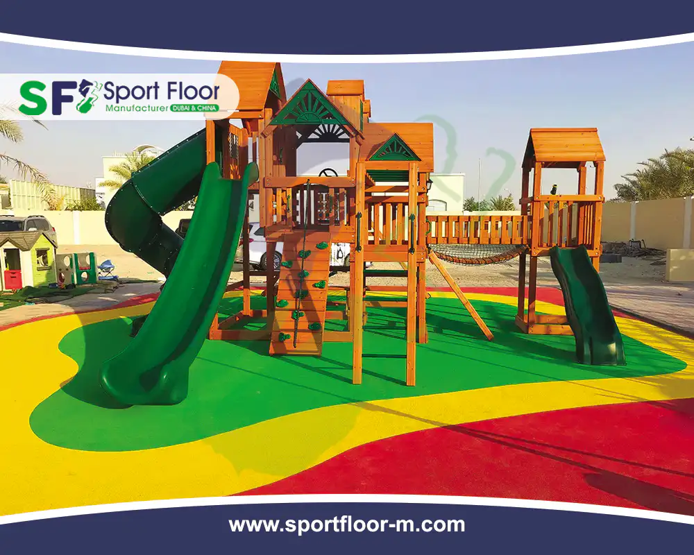 Completed colored recreational rubber surface beneath playground equipment