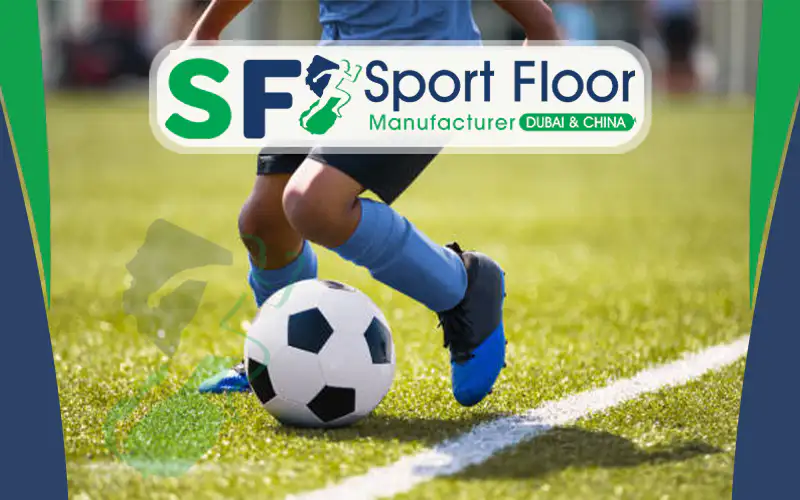 Football player controlling a ball on artificial grass