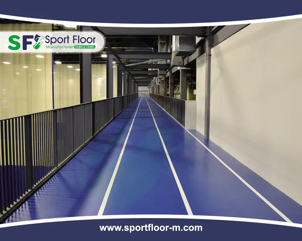Straight blue indoor running track with white lane markings