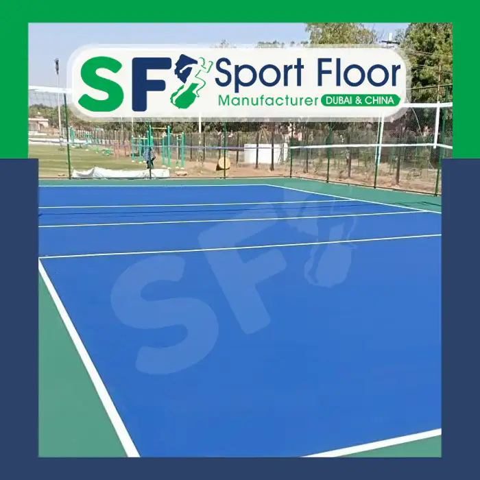 Blue outdoor volleyball court with green perimeter
