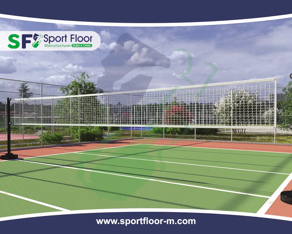 Outdoor green volleyball court with red free zone and perimeter fencing