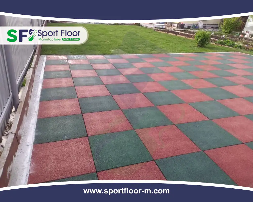 Red and green rubber tiles installed in an outdoor checkerboard layout