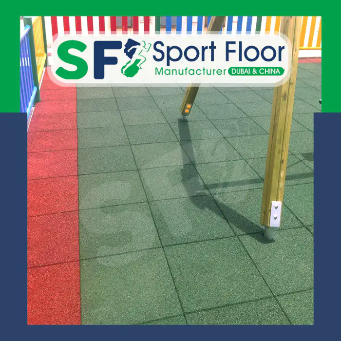 Green and red rubber tiles installed beneath playground equipment